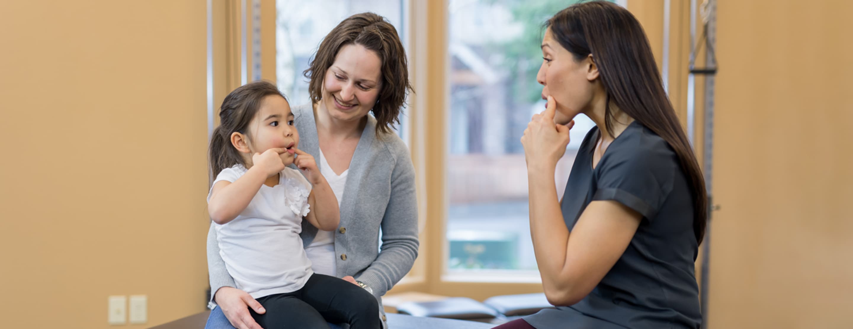 Speech therapist working with mother and child at KidStart Pediatric Therapy clinic in Burnaby BC