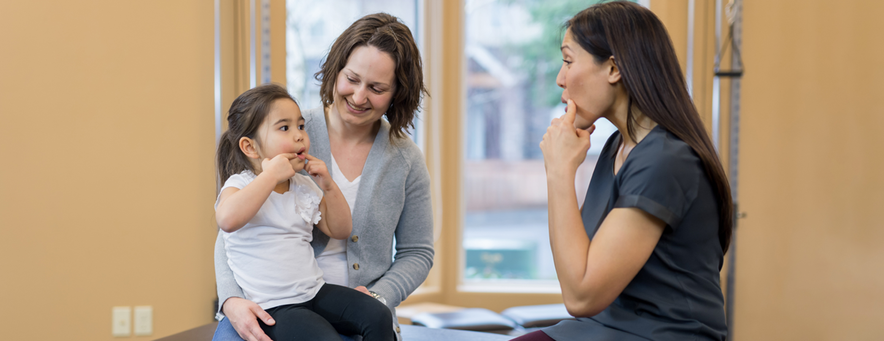 Speech therapist working with mother and child at KidStart Pediatric Therapy clinic in Burnaby BC